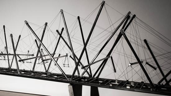 An architectural model of a suspended bridge structure.