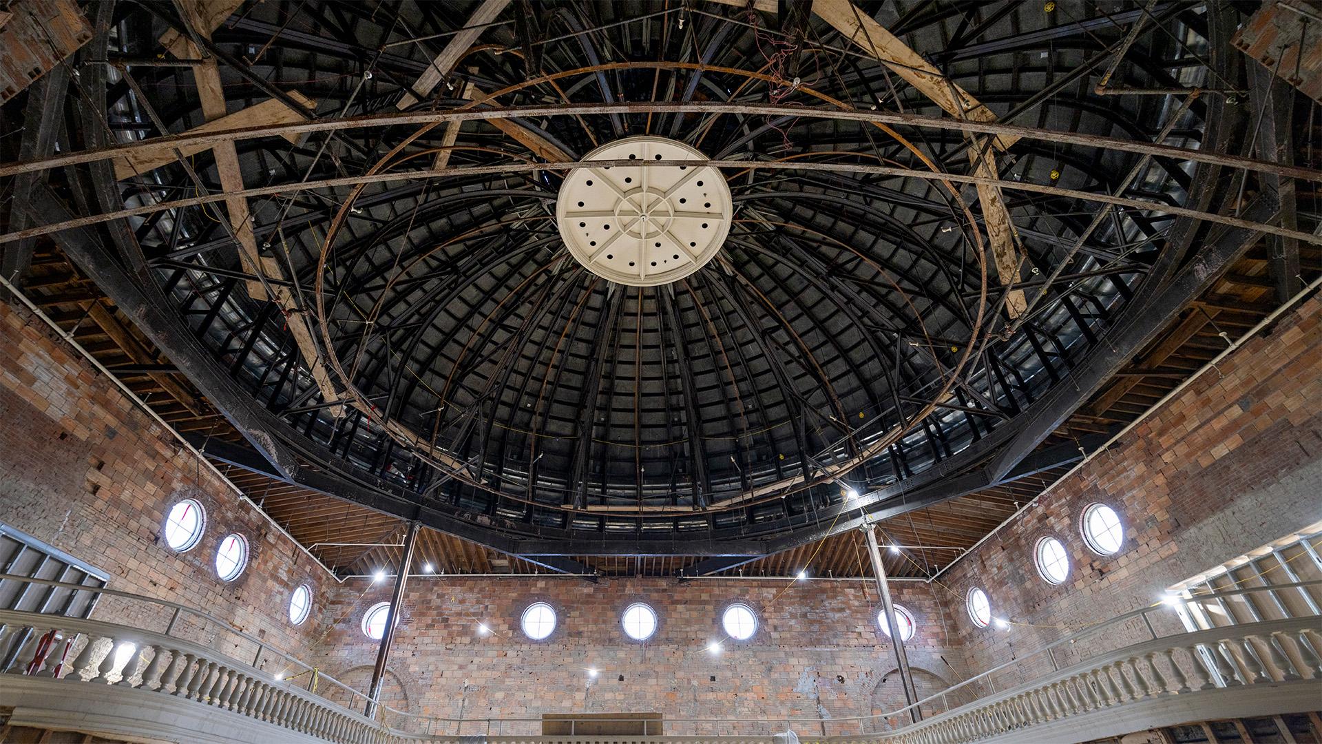 an interior view of a domed building under construction