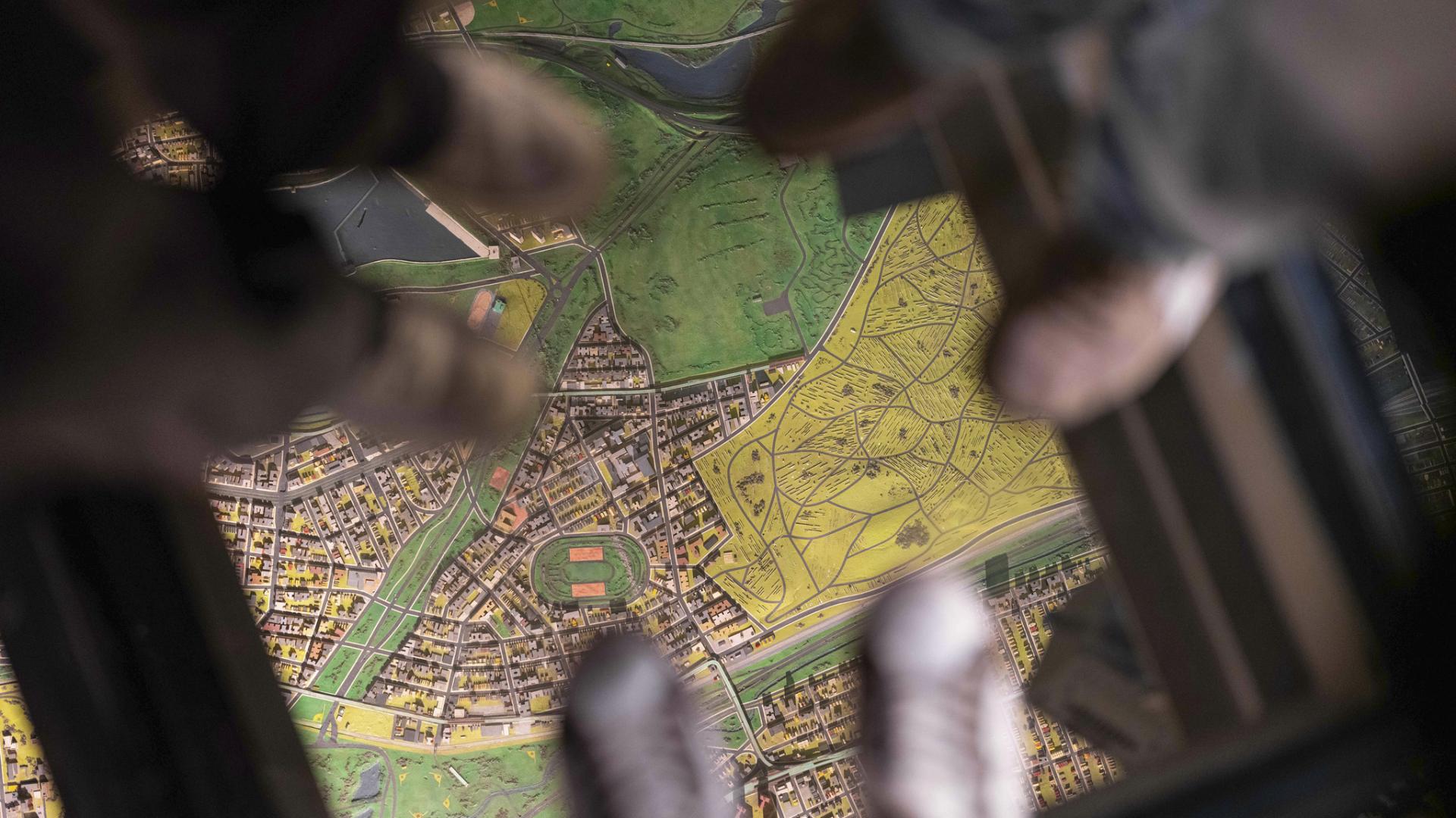 students standing on a glass floor with a map underneath