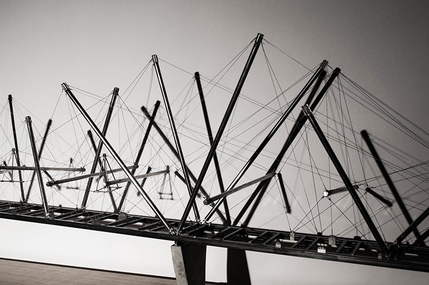 An architectural model of a suspended bridge structure.