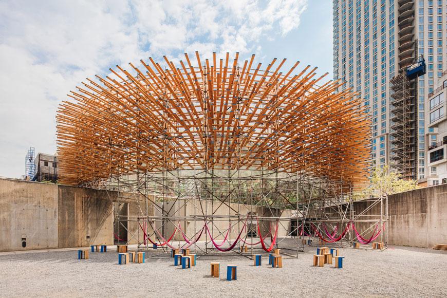 Digital rendering of an open outdoor structure whose underside consists of suspended hammocks. 