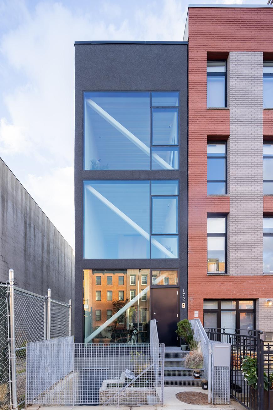 A modern townhouse next to a traditional townhouse