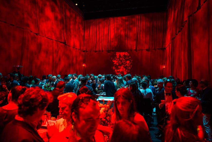 interior of a space that is illuminated solely by red and cyan lighting. 