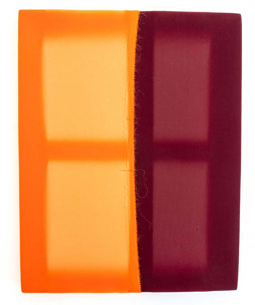 Strokes of paint with the left side painted orange and right side painted maroon with two smaller rectangles painted a lighter shade of color inside.