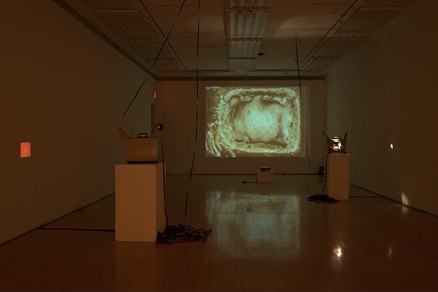 Image of projection with two projectors on pedestals.