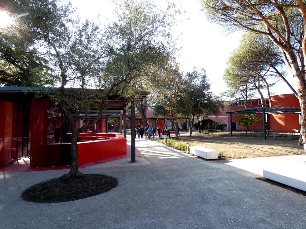 school park with red structures, trees and pathways