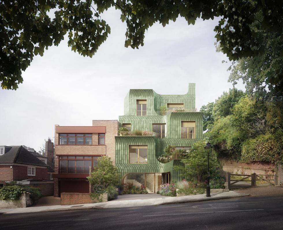 A tan and green building seen between trees