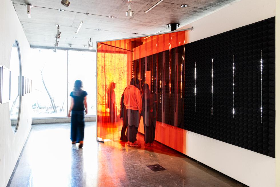 A photo of people standing inside a booth with AI conversation capability.