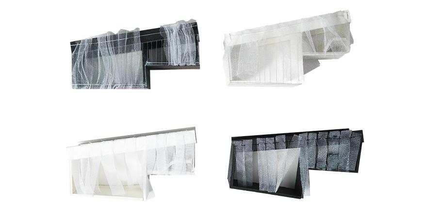 Photograph with white background of study models made from fabric and white and black materials.