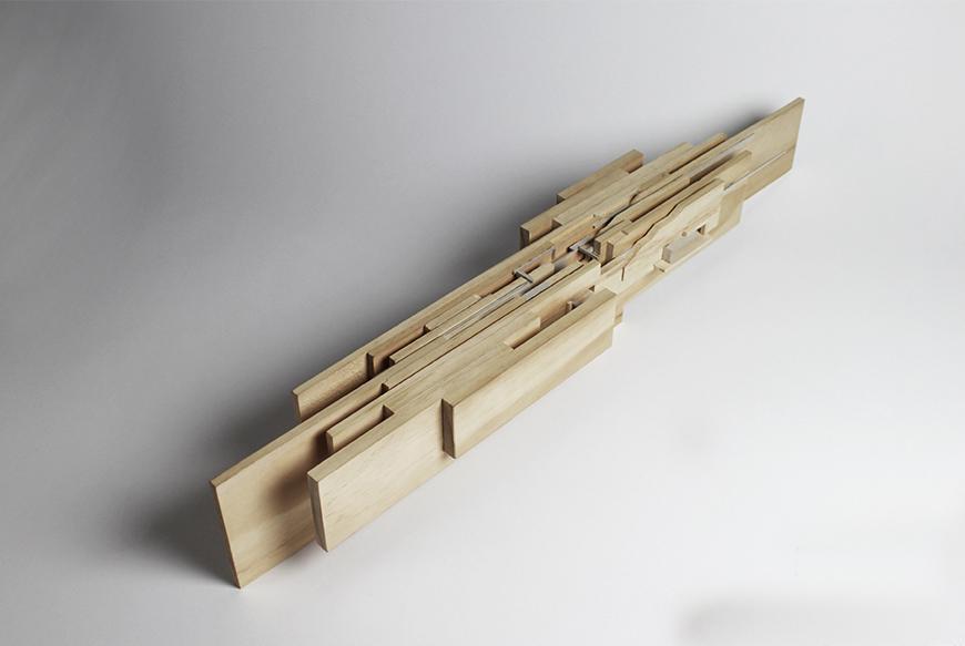 Photograph of study model made of vertical wooden boards layered together. 