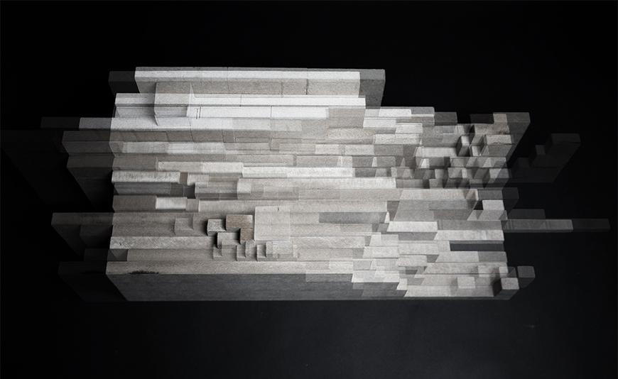 Multiple exposure photograph taken from above of vertical sections of composite wood boards assembled together to form a topological mass.