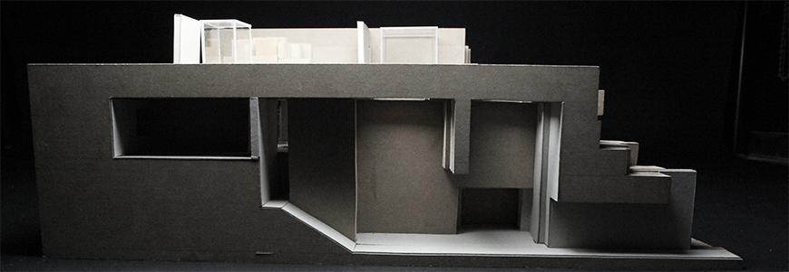 Photograph of model made from plexiglass and chipboard showing cross-section of project.