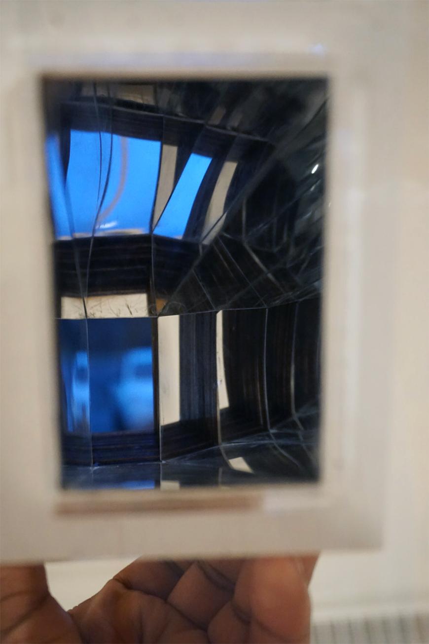 Photograph of study model held up to the camera to show effect of reflective interior walls.