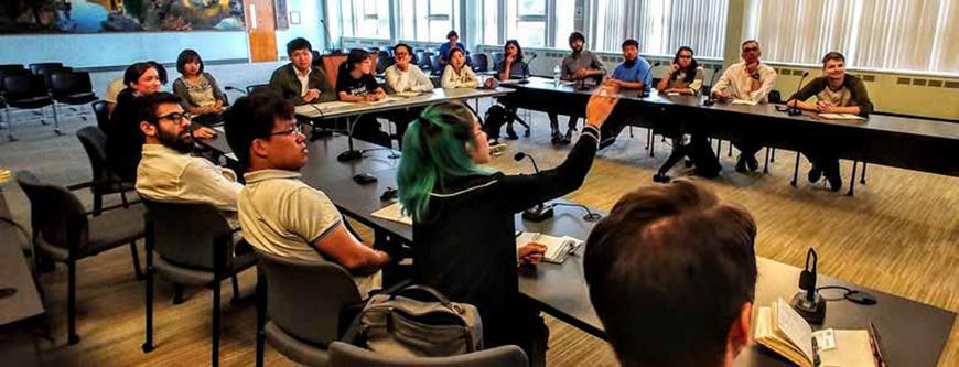 people seated around tables in a U-shape