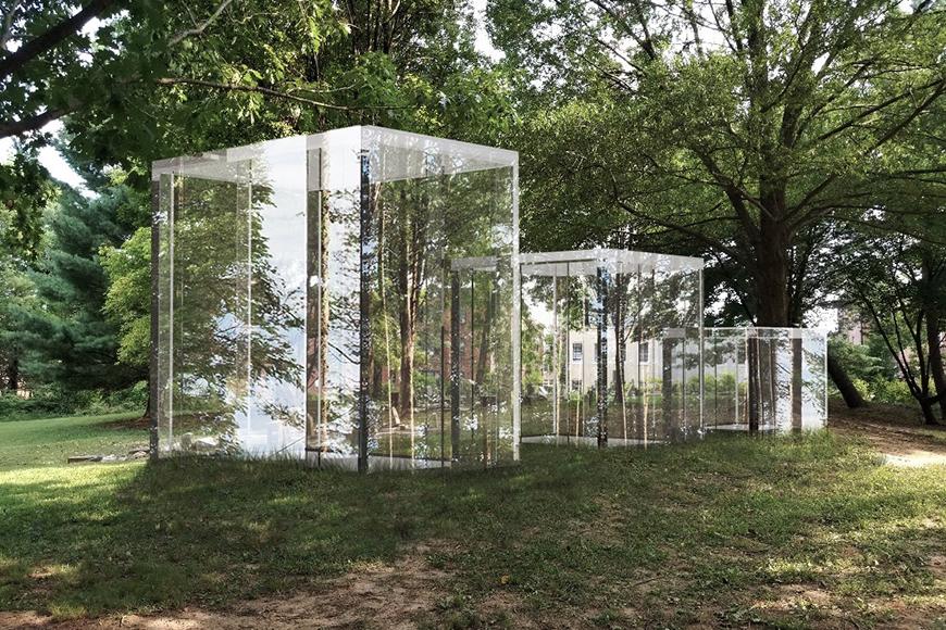 Digital rendering of a glass pavilion in a wooded setting. 