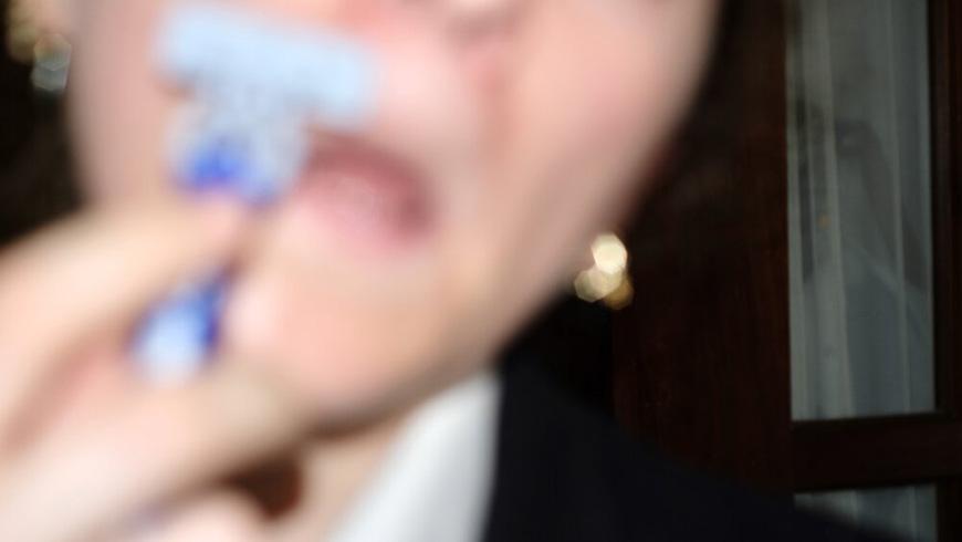 blurry photograph of a person shaving their facial hair