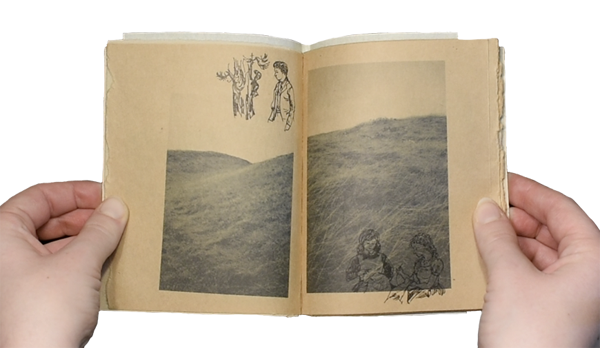 Light skinned hands holding a handmade book open. The sepia pages have an image of a mountainside printed in black ink, split by the center bind. Imposed on the photo are line drawings of children. 