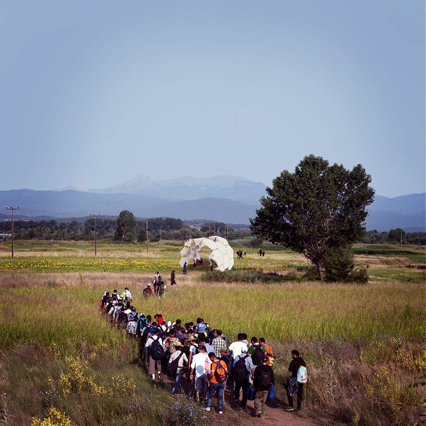 People walking toward a white structure. 