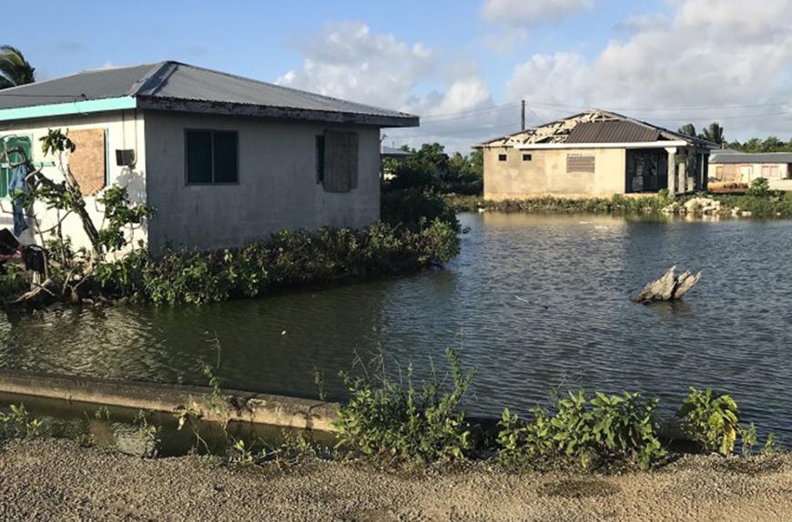 water level at the base of boarded-up buildings