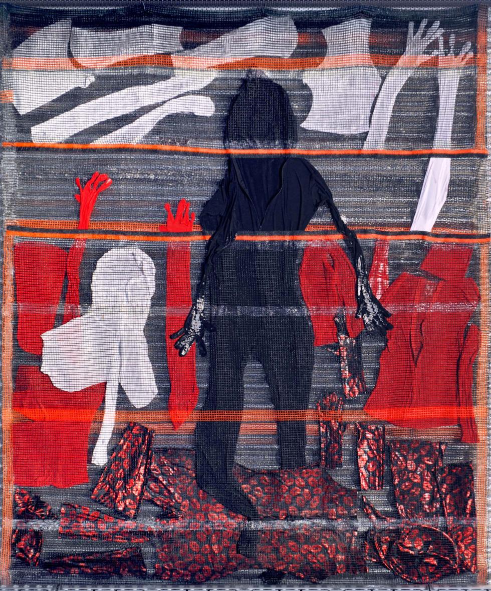 A dark abstract figure standing with different layers of dark red, white, and grey fabric.