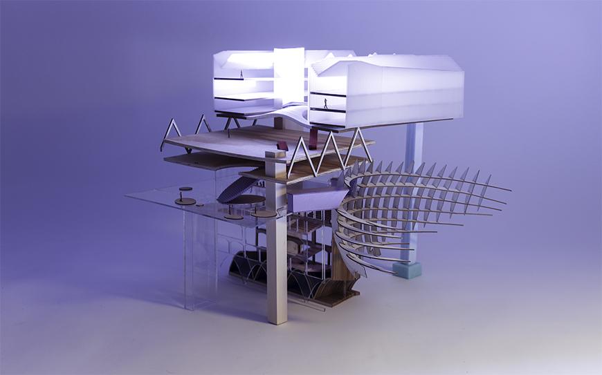 Model of collaged parts photographed with a light emitting a purple glow.