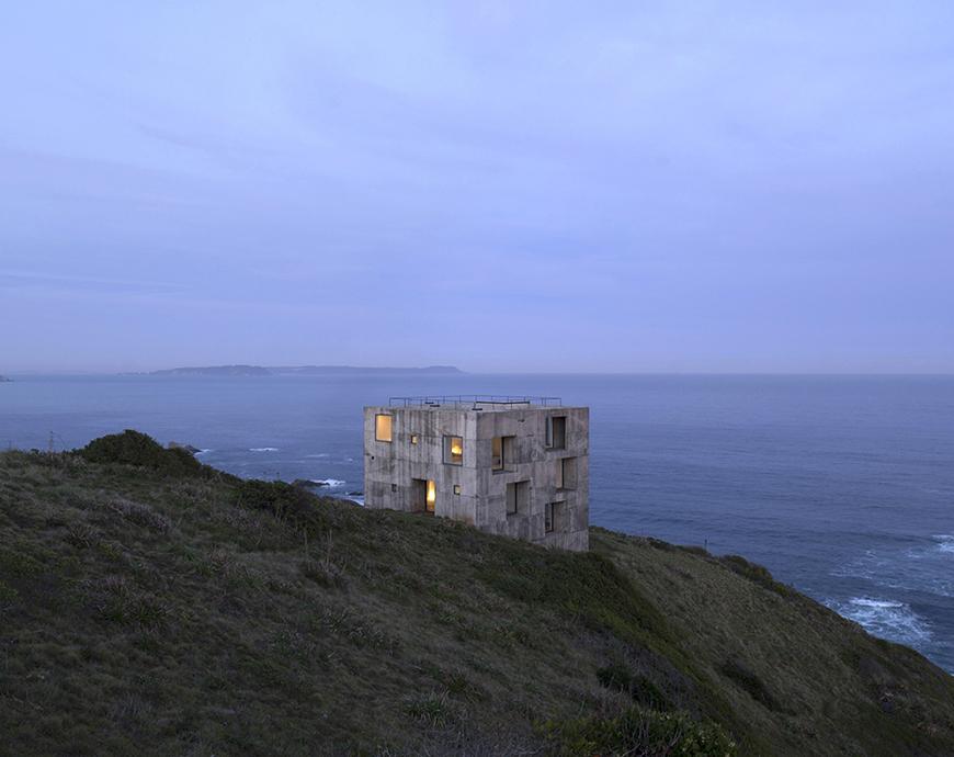 a concrete building on a seaside cliff top 