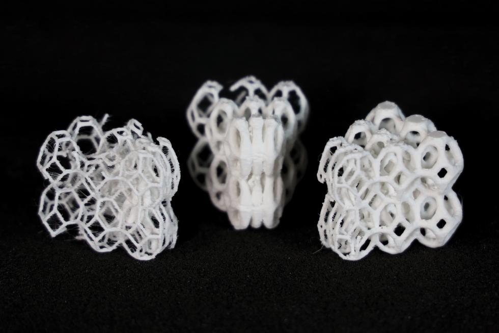 Three 3D-prints of a porous brick-like structure, each with different levels of thickness.