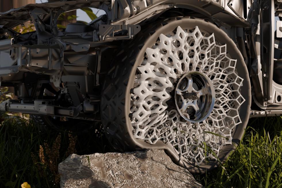 A car tire envoleping a wheel made a porous structure. The tire and wheel are distorted as they drive over a large boulder.