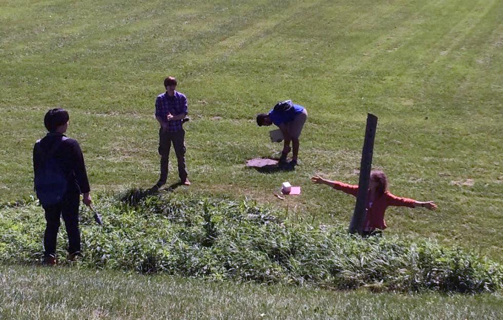 four students in a field