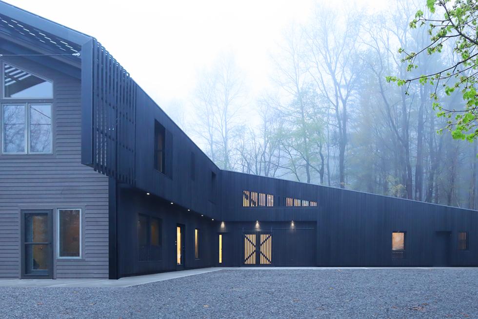 A modern wooden buidling on a misty day