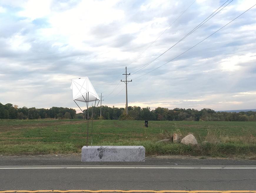 Image outside of a concrete block with steel holding up a t-shirt.