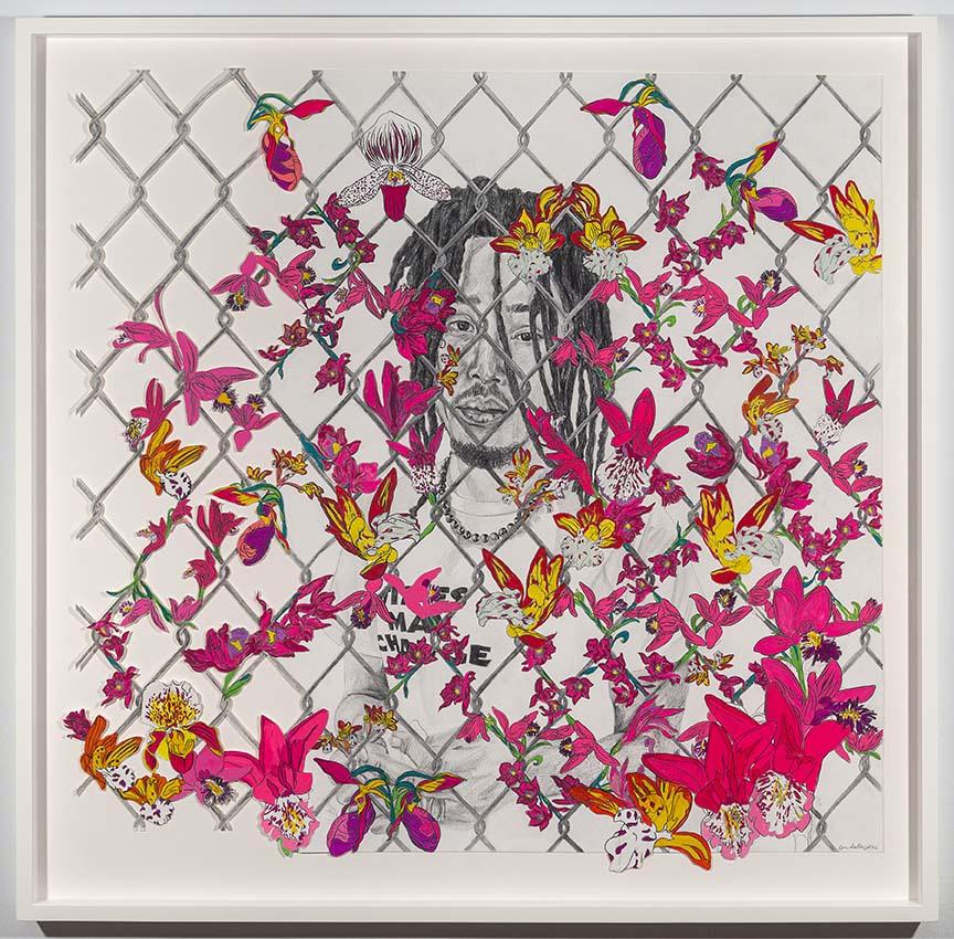 Person with shorter braided hair looking at viewer behind a wire fence covered in pink and purple butterflies and flowers.