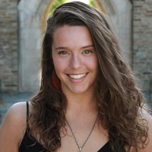 A young woman with long, brown wavy hair.