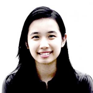 headshot of a young woman with long dark hair wearing a black shirt