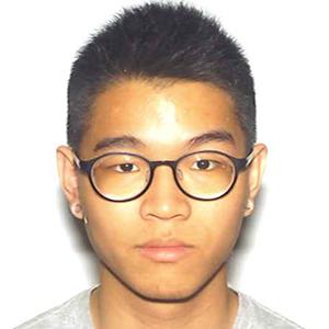 headshot of a young man with dark hair and glasses