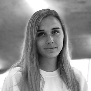 Black and White portrait of a young woman with long hair, wearing a light colored shirt. 