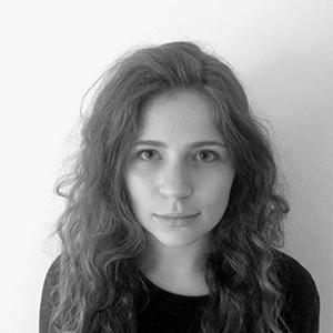 black and white headshot of a woman with long, light brown hair wearing a dark shirt