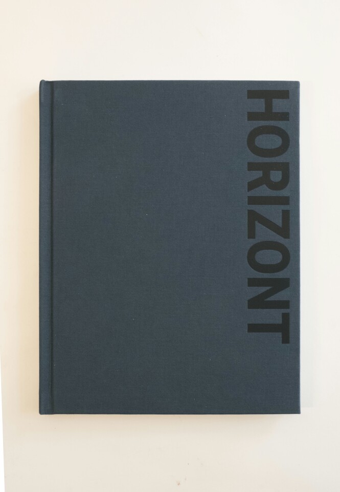 Dark blue book cover with vertical text on the left side, on a white background.
