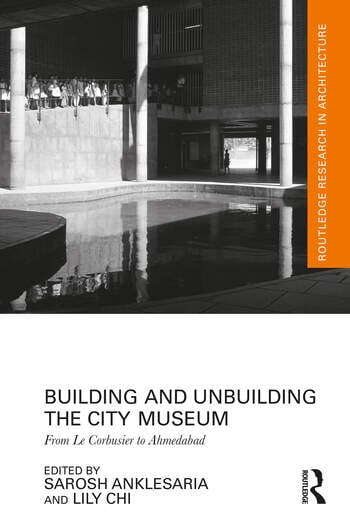 A book cover with a black and white photo of a large building and text with the book information.