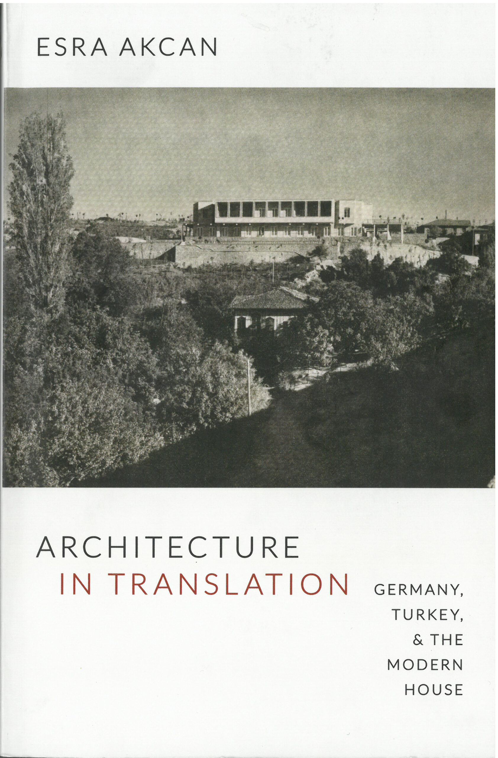 Book cover of a building on a hill with a dense forest in the foreground