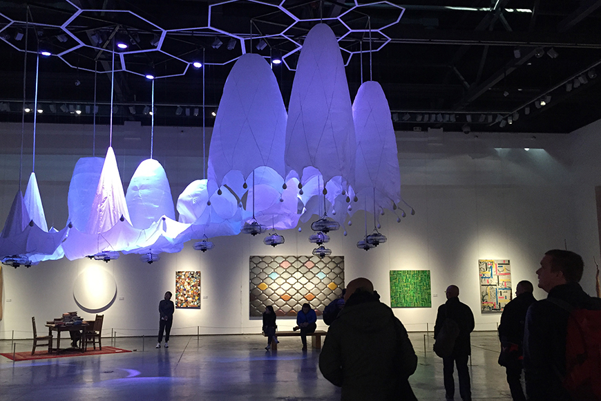 suspended purple dome shaped art work in a gallery