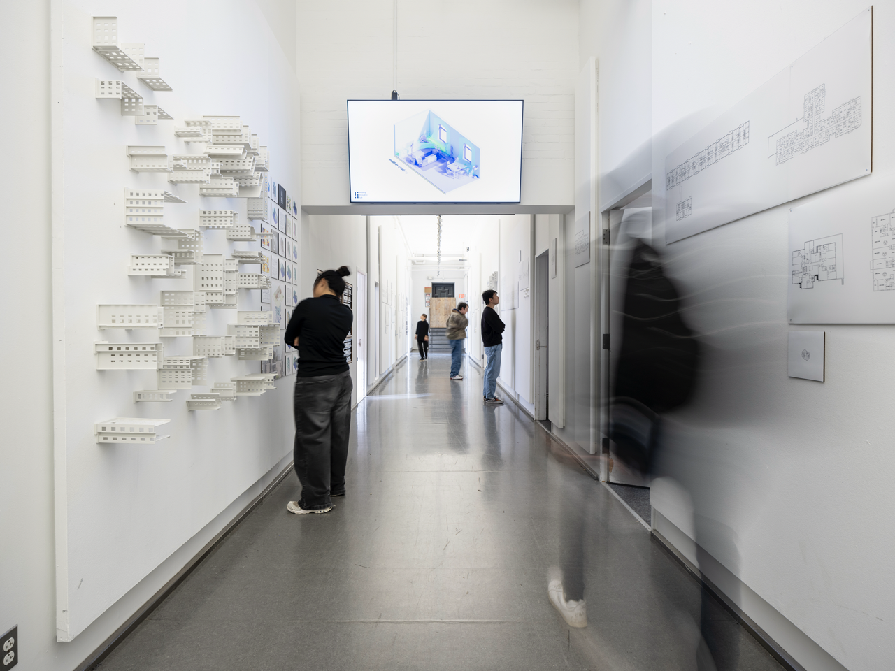 People viewing an installation in a hallway