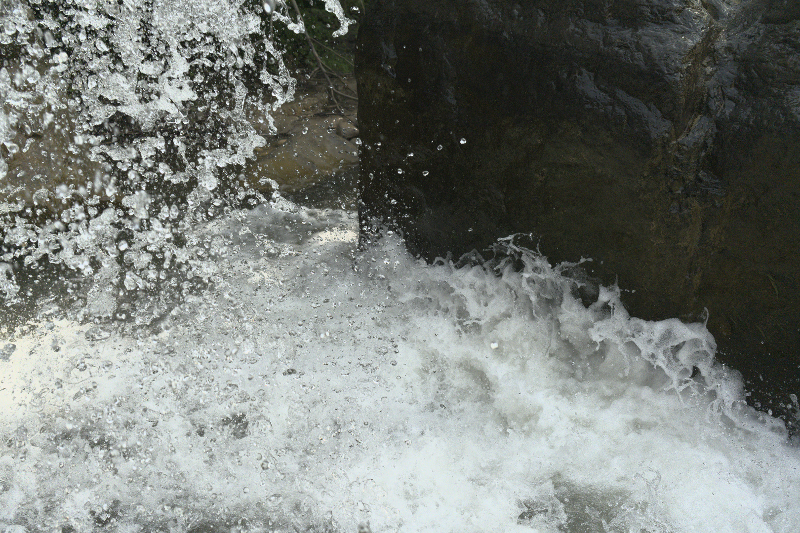 Detailed closeup of foam splashing up from a wave