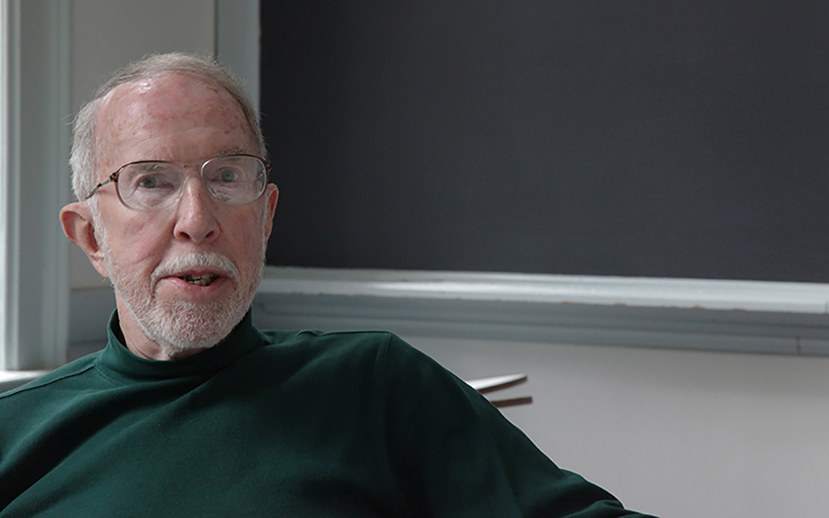 man with glasses in a green turtleneck