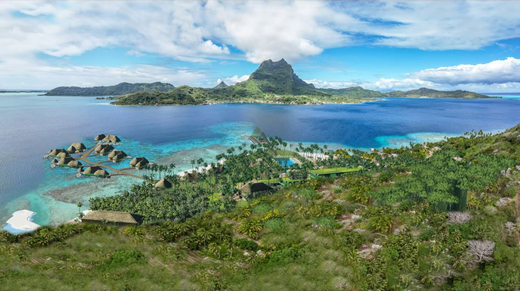Aerial view over dense greenery along the coast and a brilliant blue body of water, toward a distant mountain.