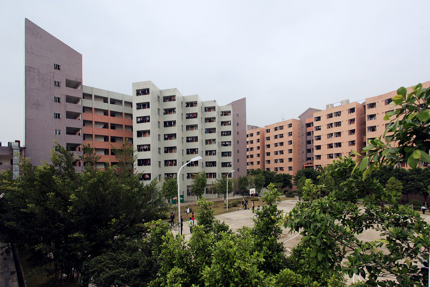 View of grey and brick-colored dorm building exteriors.