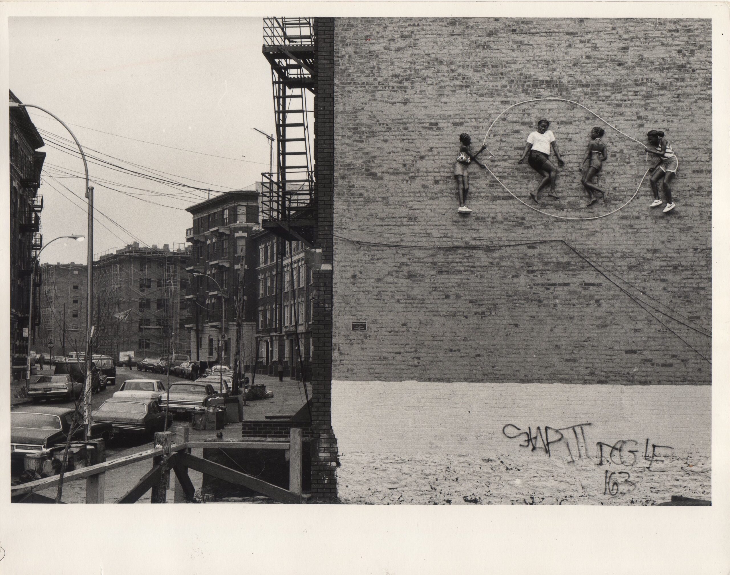 a black and white photograph of sculptural figures relief on the side of a building