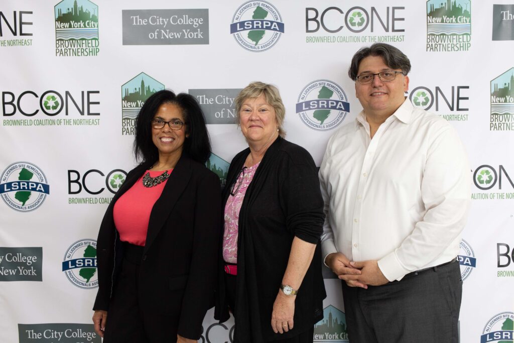 Two women and a man pose for a photo