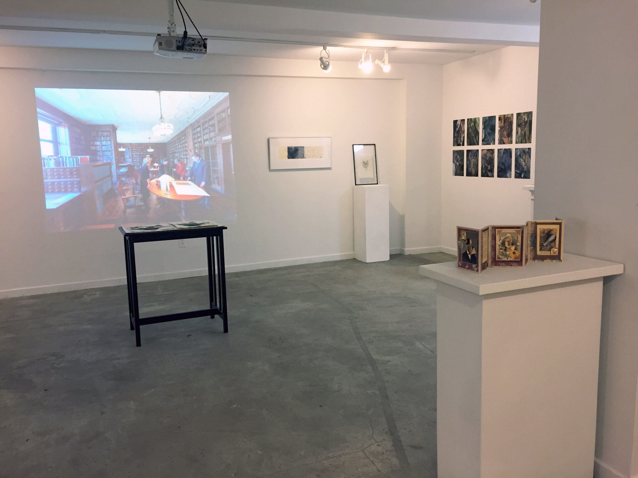 An image is projected onto a white wall as part of an exhibition.