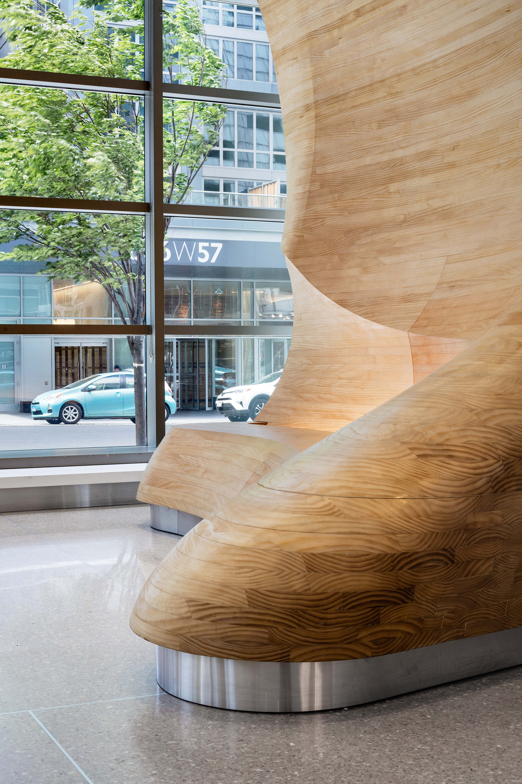 Close-up view of wooden architectural detail in apartment building lobby.
